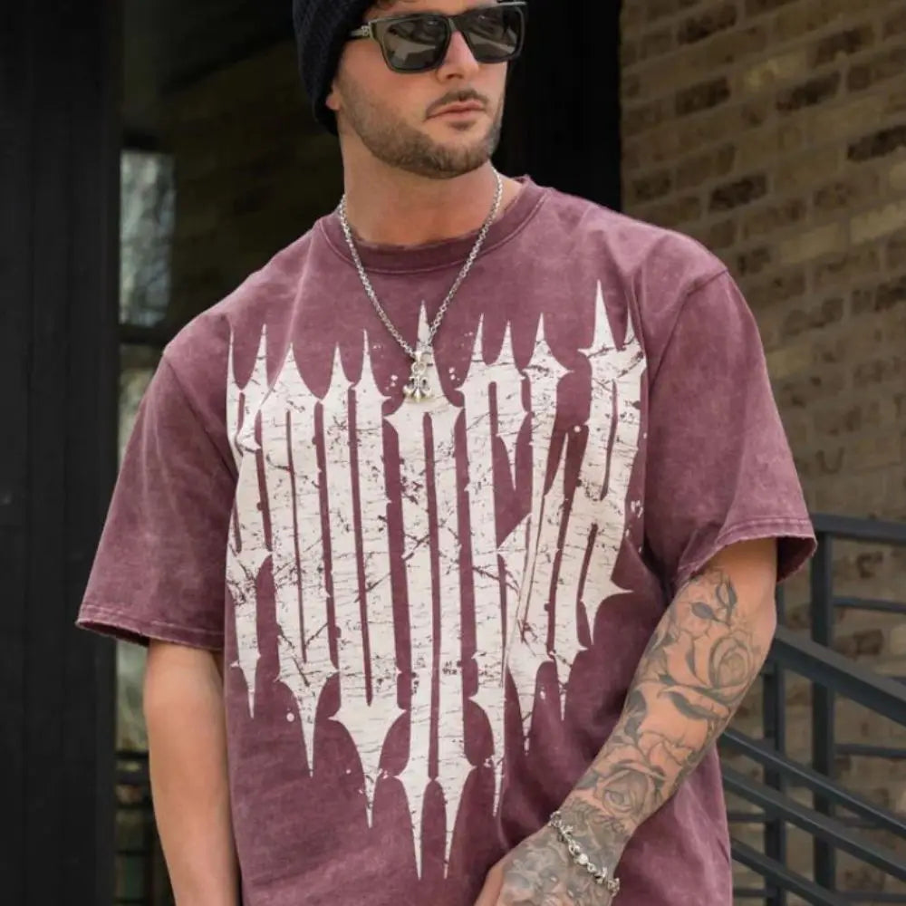 Man wearing Active Comfort Tee with bold graphic design, showcasing modern streetwear style outdoors.